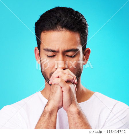 Praying, hands and man in meditation or worship to God for faith or belief in spirituality, mindfulness and peace in studio. Christian, prayer and person with religion and zen on blue background 118414742