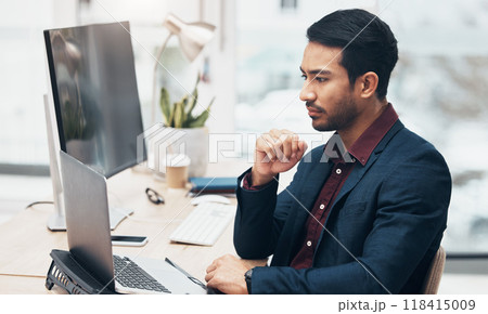 Office, brainstorming and man at computer thinking of ideas for online project with concentration and focus. Planning, analytics and Indian businessman on web search for startup business idea at desk 118415009