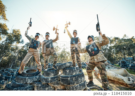 Paintball, celebrate and team of people winning a battle due to teamwork or collaboration together in woods or nature. Victory, sports and army with success on the battlefield with guns in the air 118415010