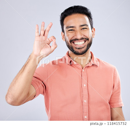 Portrait, hand sign and perfect with a man in studio on a gray background to gesture okay. Emoji, success and good news with a handsome young man indoor to display his approval or agreement 118415732