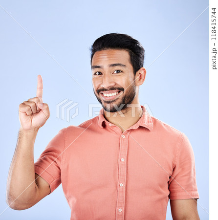 Happy, portrait and man pointing in a studio to mockup space for advertising, marketing or product placement. Happiness, smile and male model showing mock up while isolated by a purple background. 118415744