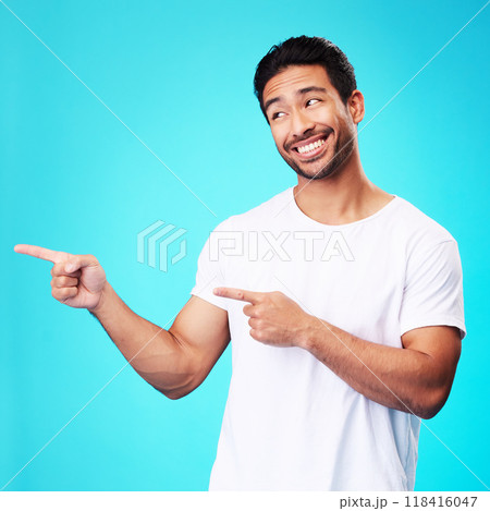 Mockup, pointing and man with a smile, thinking and choice against a blue studio background. Male person, decision or model with product placement, hand gesture and presentation with sign and showing Mockup, pointing and man with a smile, thinking and choice against a blue studio background. Male person, decision or model with product placement, hand gesture and presentation with sign and showing 118416047
