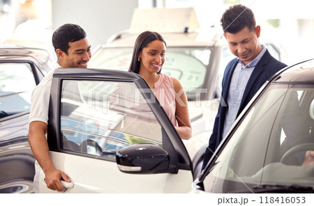 Couple at car dealership, choice and transport with salesman, people buying new transportation with luxury. Happy with decision, man and woman at automobile showroom with purchase and browsing cars Couple at car dealership, choice and transport with salesman, people buying new transportation with luxury. Happy with decision, man and woman at automobile showroom with purchase and browsing cars 118416053