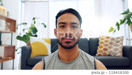 Man, portrait and living room for zen on floor for mental relax, peace or calm for strong mindset. Asian male person, workout clothes and balance or mindfulness in apartment for health and wellness 118416100