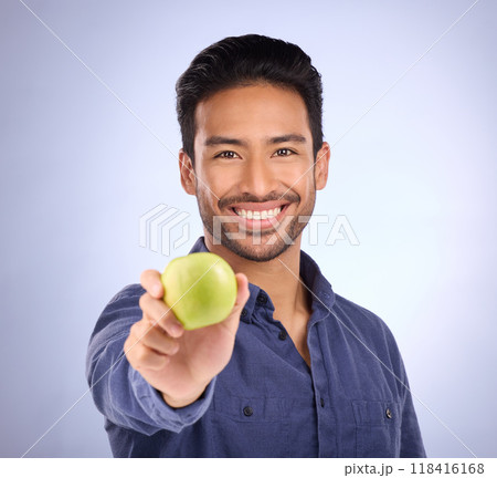Portrait of happy man with apple isolated on studio background healthy diet, healthcare or nutritionist breakfast. Vegan person or asian model with green fruit or food for dietician care and choice 118416168