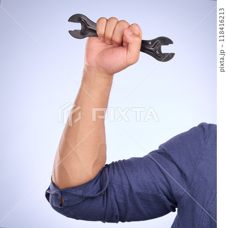 Man hand holding wrench isolated on studio background for repair solution, maintenance or plumbing power. Professional worker, person or plumber with mechanic tools or gear for hard work or labor job 118416213
