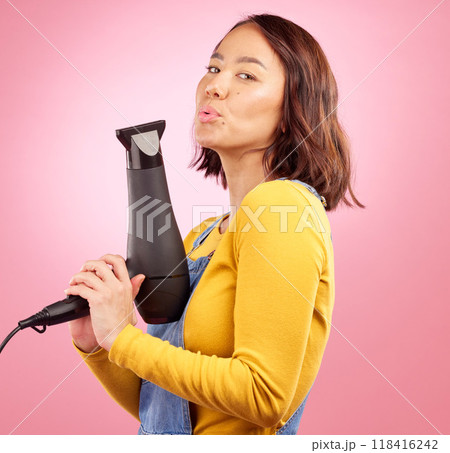 Hairdryer, salon and funny with portrait of woman in studio for hairdresser, beauty and cosmetics. Shampoo, hair care and hairstyle with face of asian person on pink background for product and gun 118416242