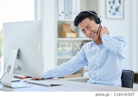 Call center, neck pain and man consulting for customer service while suffering arthritis or inflammation in office. Spine, headache and asian male consultant with posture issue while working for crm 118416307