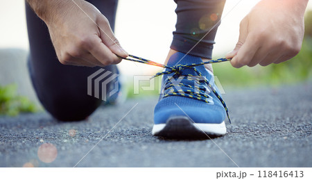 Shoes, hands and man tying shoelace for run, fitness outdoor for exercise, cardio and active with health and closeup. Sports, running sneakers and male person start workout with bokeh and training Shoes, hands and man tying shoelace for run, fitness outdoor for exercise, cardio and active with health and closeup. Sports, running sneakers and male person start workout with bokeh and training 118416413