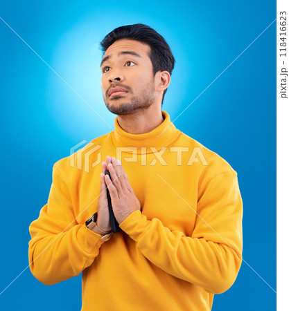Peace, man with hand gesture and praying against a blue background for worship. Thank you or faith, spiritual growth or meditation and young male person with emoji hands sign for religion in studio Peace, man with hand gesture and praying against a blue background for worship. Thank you or faith, spiritual growth or meditation and young male person with emoji hands sign for religion in studio 118416623