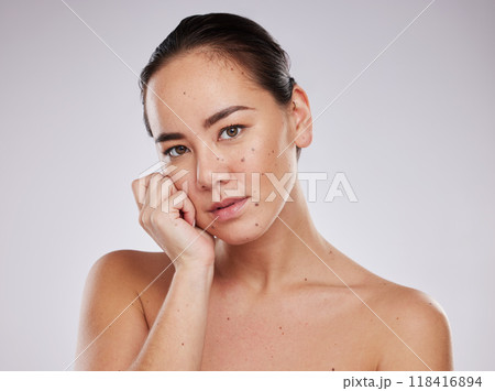 Skincare, face and portrait of a woman in studio for beauty, dermatology and cosmetics for skin glow. Aesthetic asian model person with hand for makeup, mole and facial self care on grey background Skincare, face and portrait of a woman in studio for beauty, dermatology and cosmetics for skin glow. Aesthetic asian model person with hand for makeup, mole and facial self care on grey background 118416894
