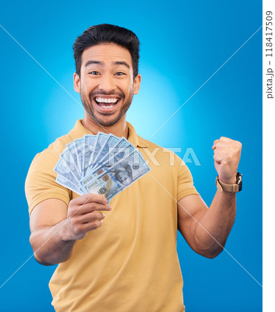 Money, fist pump portrait and man excited for dollar bills, financial achievement award or bonus salary prize. Show cash, happy winner and person cheers for income, revenue or win on blue background 118417509