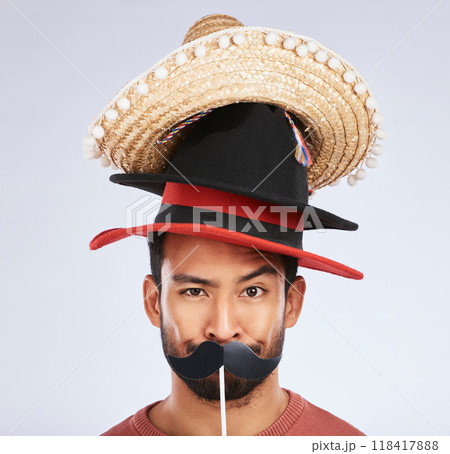 Photo booth, hat and portrait of man with mustache for comic, humor and funny joke in studio. Happy, Mexican party accessory and silly face of male person on gray background with sombrero for comedy 118417888