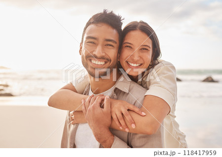 Portrait, hug and couple at the beach with happiness for a vacation in the summer having fun. Together, hugs and ocean for holiday with smile for the weekend with sunshine for relaxing and bonding. 118417959