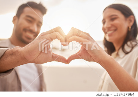 Heart hands, happy and a couple at the beach for love, date and travel together in Bali. Smile, emoji and a man and woman with a shape and hand gesture for romance, ocean holiday and bonding 118417964