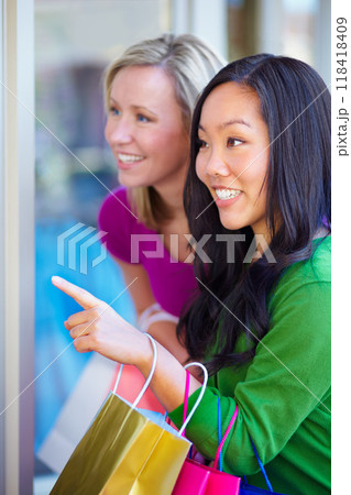Window shopping, women and bags at a mall for sale, discount and boutique promotion, happy and excited. Hand pointing, store and friends smile while talking and checking items together on the weekend 118418409