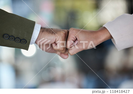 Hands, fist bump and trust in corporate partnership for unity, agreement or deal against blurred background. Hand of people bumping fists in collaboration for teamwork, goals or support for winning 118418427