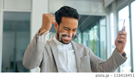 Celebrate, excited and phone of business man in office for good news or yes feedback. Success, winning and fist of asian male employee with smartphone for wow achievement, promotion or online bonus Celebrate, excited and phone of business man in office for good news or yes feedback. Success, winning and fist of asian male employee with smartphone for wow achievement, promotion or online bonus 118418451