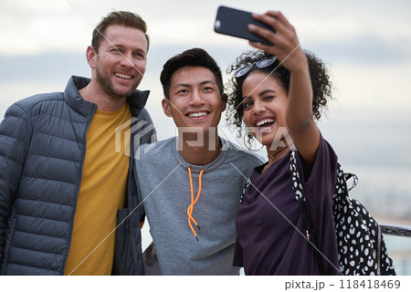 Men, black woman and friends selfie at beach for holiday travel, together and smile for internet blog post. Outdoor adventure, phone and profile picture for social media app by ocean with diversity Men, black woman and friends selfie at beach for holiday travel, together and smile for internet blog post. Outdoor adventure, phone and profile picture for social media app by ocean with diversity 118418469
