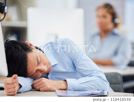 Call center, burnout or tired man sleeping on table exhausted or overworked by deadlines in overtime. Resting, dreaming or lazy sales agent with stress or fatigue napping on relaxing break at desk 118418539