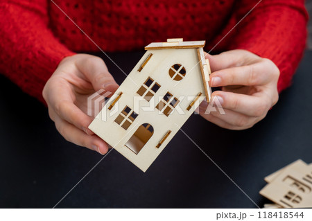 Process of preparing for Christmas and New Year eve. 3D craft wooden houses DIY. Responsible ecological zero waste handmade decoration. Children hobby activity Process of preparing for Christmas and New Year eve. 3D craft wooden houses DIY. Responsible ecological zero waste handmade decoration. Children hobby activity 118418544