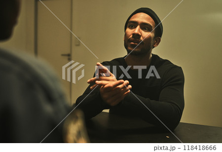 Interrogation, jail and police talking to criminal for interview, investigation and arrested in station. Security, law and officer with man, burglar or thief for crime, stealing and theft in prison 118418666