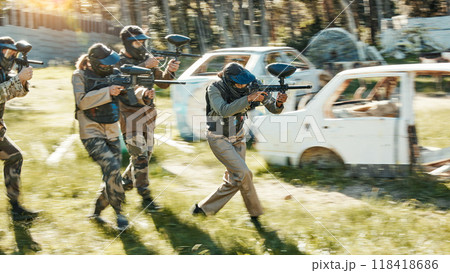 Teamwork, challenge and paintball with man in game for playground, war and gaming. Sports, mission and soldier with people shooting in battlefield arena for target, gun and warrior training 118418686