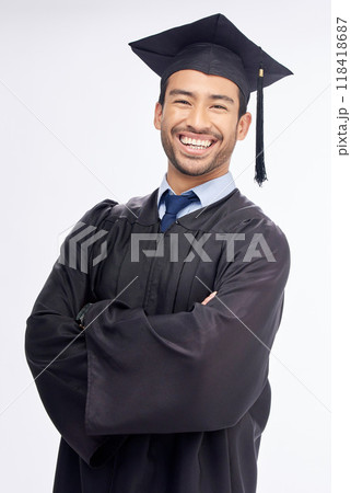 Student man, arms crossed and graduation in studio portrait, smile and success by white background. Young guy, happy university graduate and education achievement with pride, goals and celebration 118418687