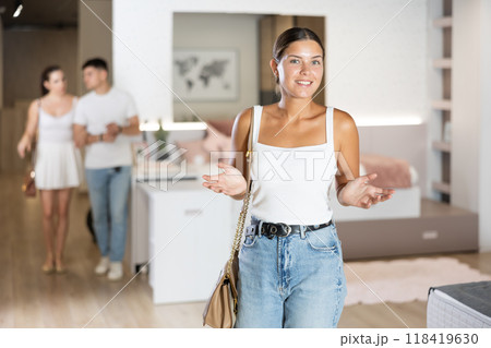 Young girl watching large stock of goods in furniture shop Young girl watching large stock of goods in furniture shop 118419630