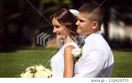 Happy groom hugging his bride  118420753