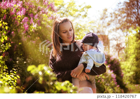 A mother holds her son in her arms. 118420767