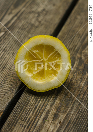 squeezed part of lemon on wood . High quality photo squeezed part of lemon on wood . High quality photo 118424754
