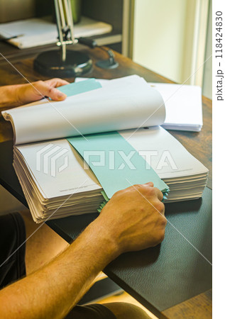 male holding the stack of paper on the home office . High quality photo male holding the stack of paper on the home office . High quality photo 118424830