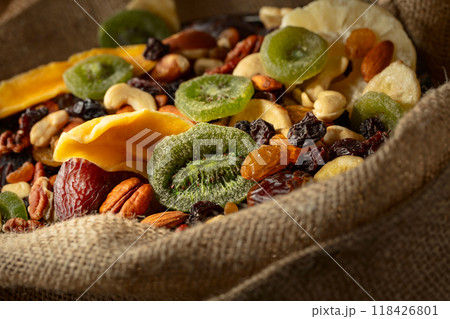 Dried tropical fruits and nuts in burlap bag. 118426801