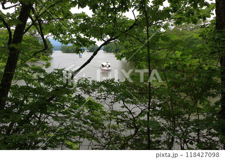 A small boat on Lake Onuma in Onuma Quasi-national Park near Nanae town on the Oshima peninsula in southwest Hokkaido, Japan A small boat on Lake Onuma in Onuma Quasi-national Park near Nanae town on the Oshima peninsula in southwest Hokkaido, Japan 118427098