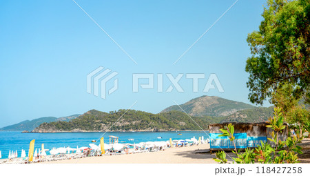 Beach View with Sun Loungers and Bars Along the Shoreline Beach View with Sun Loungers and Bars Along the Shoreline 118427258