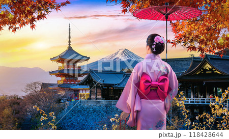 Asian woman wearing japanese traditional kimono enjoying autumn season at sunset in Japan. 118428644