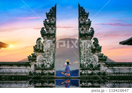 Young woman standing in temple gates at Lempuyang Luhur temple in Bali, Indonesia. 118428647