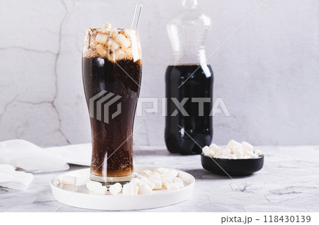 Trendy drink of cola and marshmallow in a glass on the table 118430139