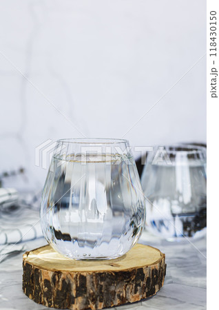 Clean organic water in glasses on table against background in shadows vertical view 118430150