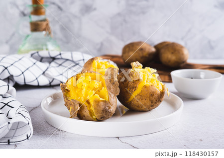 Young potatoes boiled in their skins on a plate on the table Young potatoes boiled in their skins on a plate on the table 118430157