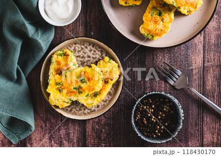 Delicious fried potato and broccoli sticks on a plate on the table top view 118430170