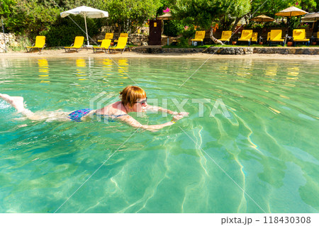 Woman Swimming in Turquoise Tropical Sea Woman Swimming in Turquoise Tropical Sea 118430308
