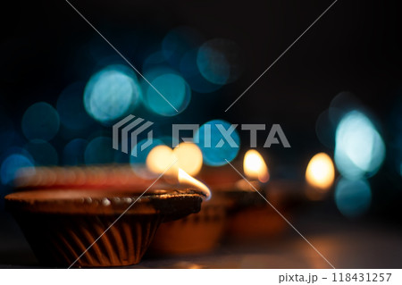 Glowing clay lanterns during Indian festival Diwali celebrations with bokeh effect background with copy space. Glowing clay lanterns during Indian festival Diwali celebrations with bokeh effect background with copy space. 118431257