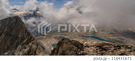 Panoramic Alpine View with Clouds and Snow-Capped Peaks 118431671