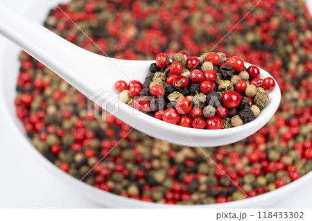 Different varieties of peppercorns, red, green, black and white peppers in a spoon Different varieties of peppercorns, red, green, black and white peppers in a spoon 118433302