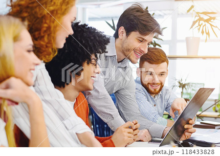 New business plan. Young cheerful people looking at clipboard at coworking workplace, free space 118433828