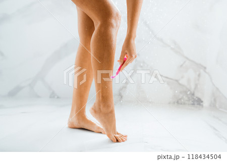 Depilation and bodycare concept. Woman shaving legs, taking shower, crop Depilation and bodycare concept. Woman shaving legs, taking shower, crop 118434504