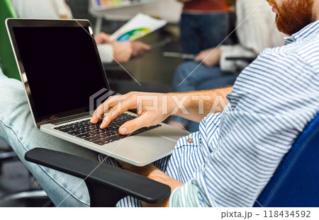 Analyzing finances of business. Self-employed entrepreneur working on laptop with blank screen, panorama 118434592