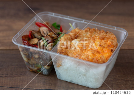 A box of stir-fried duck with Thai basil, served over steamed rice and topped with a perfectly fried egg. A box of stir-fried duck with Thai basil, served over steamed rice and topped with a perfectly fried egg. 118434636